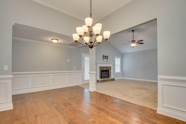 702 Southwick Ave, Grovetown, GA 30813 - unfurnished living room with ceiling fan with notable chandelier, wood-type flooring, wainscoting, and lofted ceiling