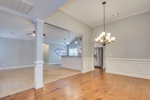 702 Southwick Ave, Grovetown, GA 30813 - unfurnished dining area featuring light wood-type flooring, ceiling fan with notable chandelier, decorative columns, and visible vents