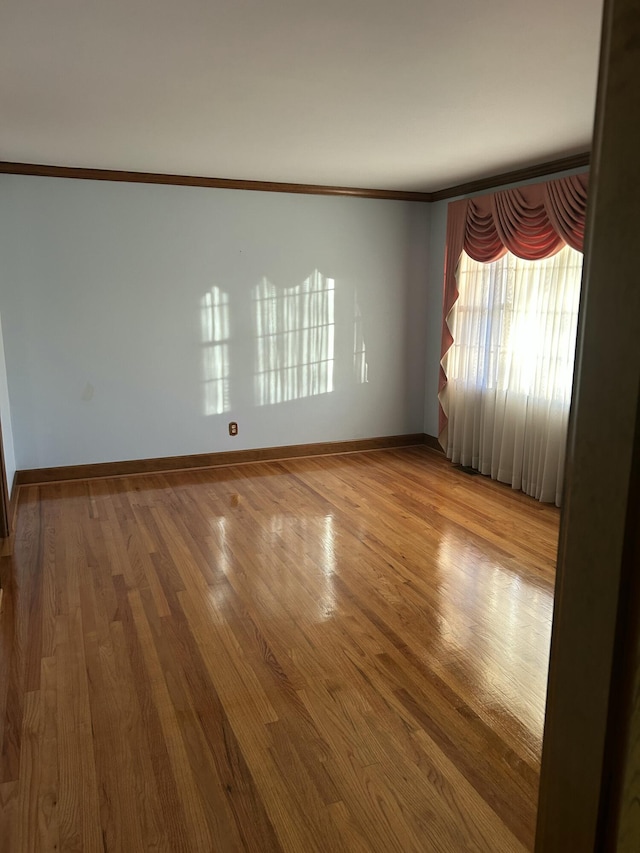 unfurnished room featuring crown molding and hardwood / wood-style flooring