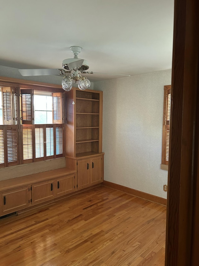 unfurnished dining area with ceiling fan and light hardwood / wood-style flooring