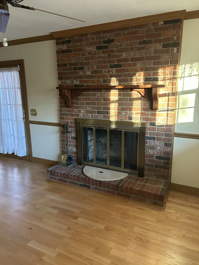 details with ornamental molding, a fireplace, and hardwood / wood-style floors