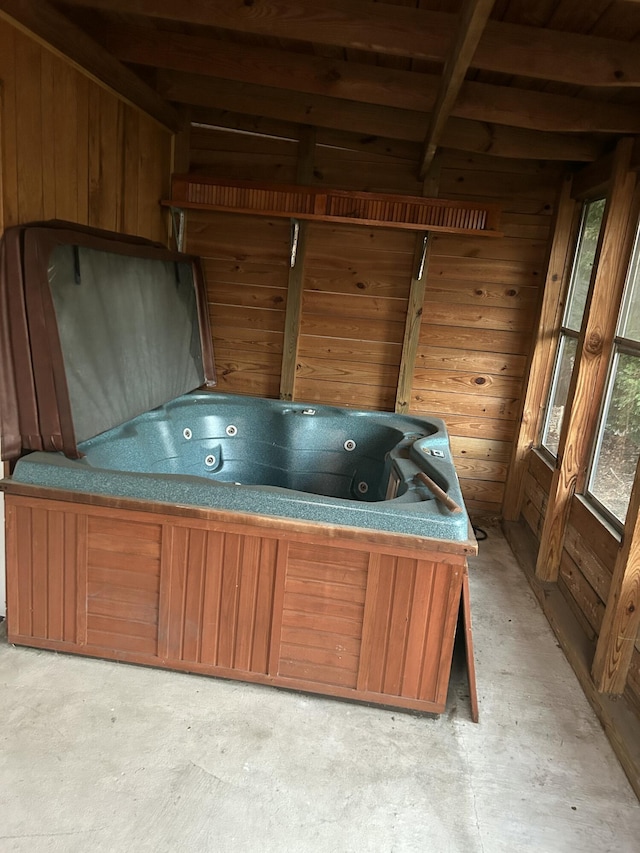 miscellaneous room featuring a jacuzzi and wood walls