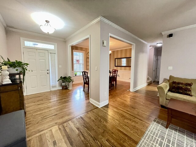 foyer featuring wood-type flooring and ornamental molding