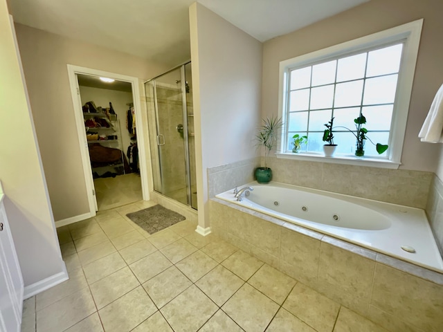 bathroom featuring tile patterned flooring and separate shower and tub