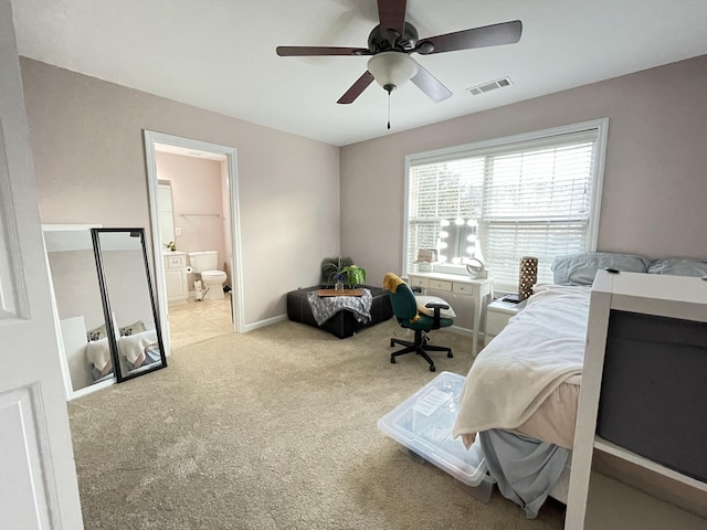 carpeted bedroom with ceiling fan and connected bathroom