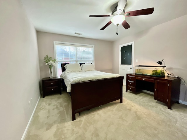 bedroom with ceiling fan and light carpet