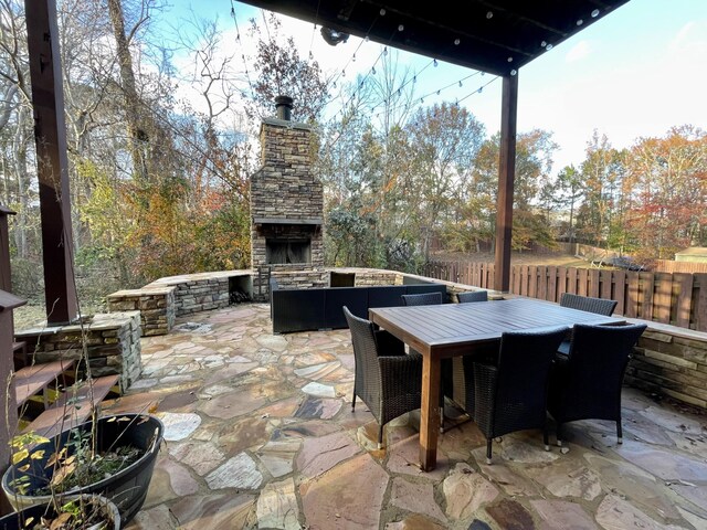 view of patio featuring an outdoor stone fireplace