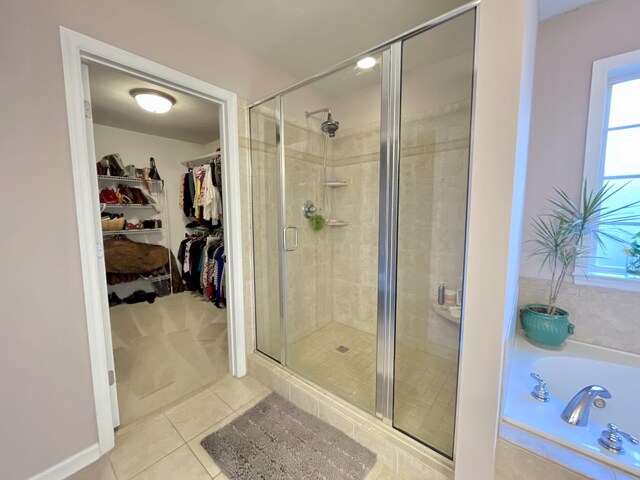 bathroom featuring tile patterned flooring and plus walk in shower