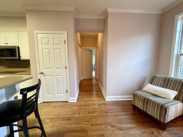 interior space featuring light hardwood / wood-style floors and ornamental molding