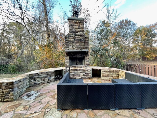 view of patio / terrace with an outdoor living space with a fireplace