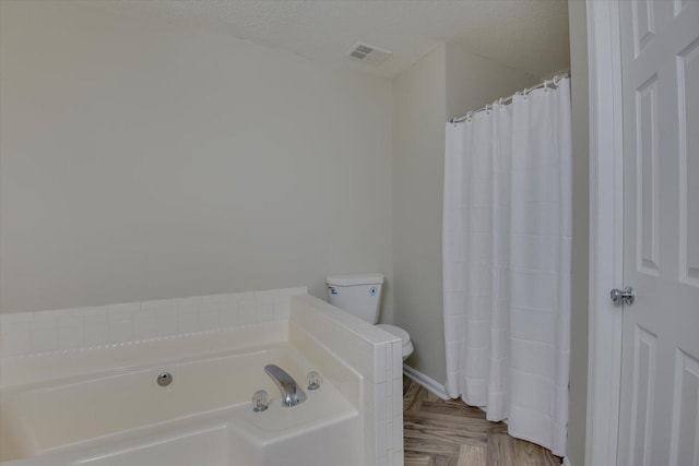 bathroom featuring a shower with shower curtain, visible vents, a textured ceiling, and a bath