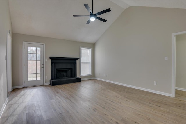 unfurnished living room with high vaulted ceiling, a fireplace, light wood-style floors, and a ceiling fan