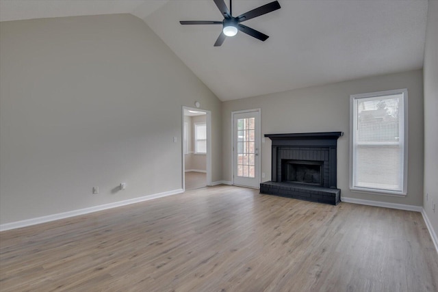 unfurnished living room with light wood finished floors, ceiling fan, high vaulted ceiling, and a fireplace