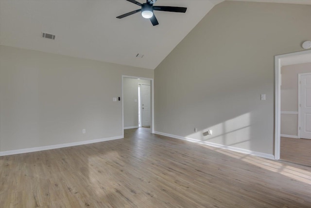 empty room with visible vents, high vaulted ceiling, a ceiling fan, and wood finished floors