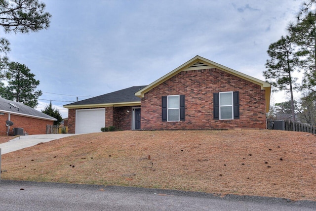 ranch-style house featuring central AC, a garage, fence, concrete driveway, and brick siding