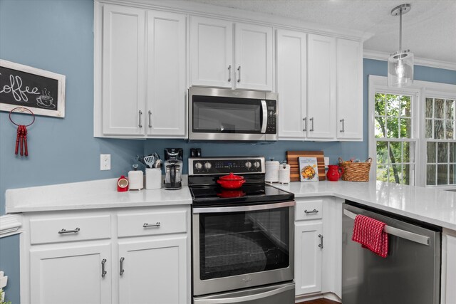 429 Cambridge Cir, Martinez, GA 30907 - kitchen featuring appliances with stainless steel finishes, white cabinets, crown molding, light countertops, and decorative light fixtures