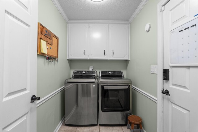 429 Cambridge Cir, Martinez, GA 30907 - laundry room with cabinet space, washing machine and dryer, a textured ceiling, crown molding, and light tile patterned flooring