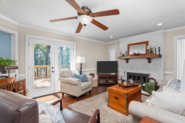 429 Cambridge Cir, Martinez, GA 30907 - living room with dark wood-type flooring, healthy amount of natural light, french doors, a brick fireplace, and crown molding