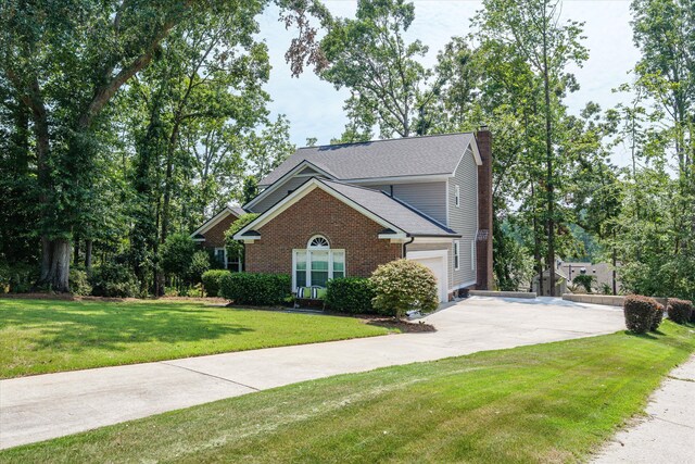 429 Cambridge Cir, Martinez, GA 30907 - view of front of property with concrete driveway, a chimney, a front yard, a garage, and brick siding
