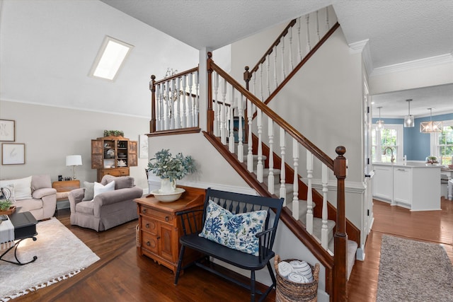 429 Cambridge Cir, Martinez, GA 30907 - stairway with wood finished floors, crown molding, a textured ceiling, and a chandelier