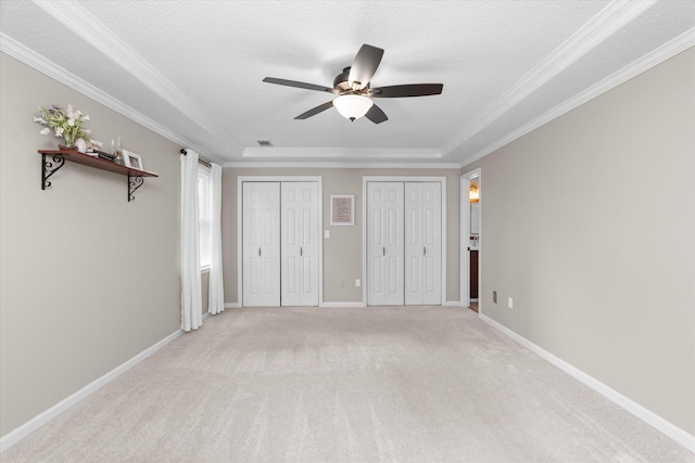 429 Cambridge Cir, Martinez, GA 30907 - unfurnished bedroom with two closets, ornamental molding, light colored carpet, a textured ceiling, and a ceiling fan