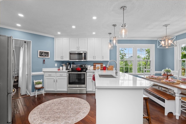 429 Cambridge Cir, Martinez, GA 30907 - kitchen with stainless steel appliances, a peninsula, crown molding, white cabinets, and light countertops