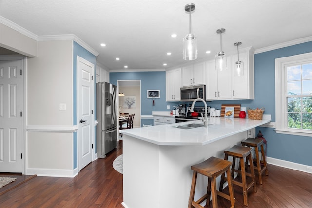 429 Cambridge Cir, Martinez, GA 30907 - kitchen featuring appliances with stainless steel finishes, a peninsula, dark wood finished floors, recessed lighting, and light countertops
