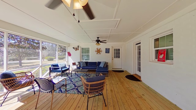 sunroom featuring ceiling fan