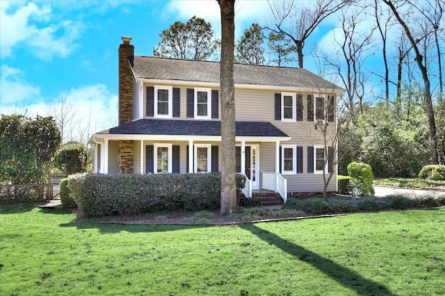 view of front of property featuring a front yard, fence, and a chimney