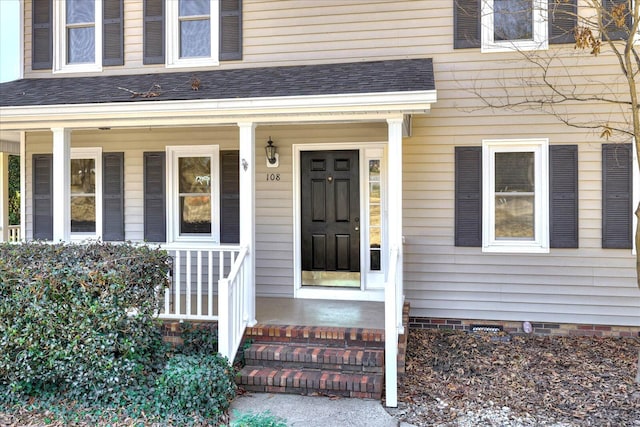 doorway to property with roof with shingles