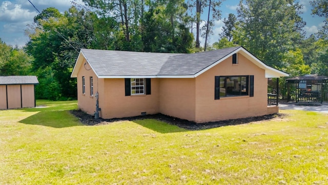 exterior space featuring a lawn and an outdoor structure