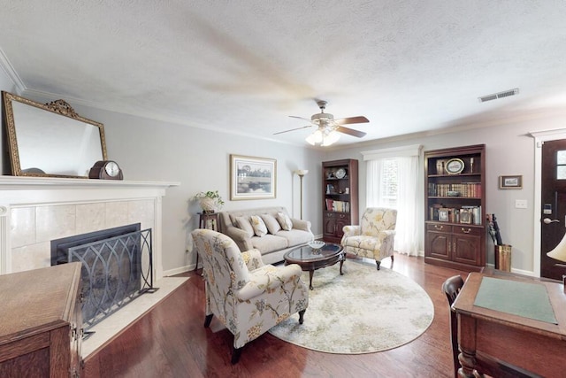 189 Mokateen Ave, North Augusta, SC 29841 - living area featuring a ceiling fan, a textured ceiling, a tile fireplace, wood finished floors, and crown molding