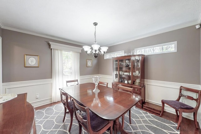 189 Mokateen Ave, North Augusta, SC 29841 - dining space featuring a chandelier, wood finished floors, wainscoting, and crown molding