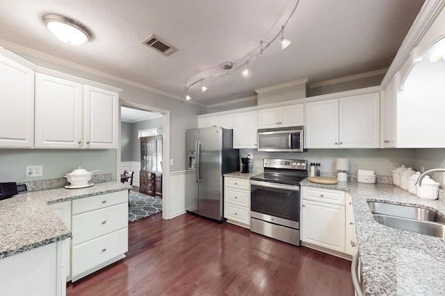189 Mokateen Ave, North Augusta, SC 29841 - kitchen with appliances with stainless steel finishes, white cabinets, dark wood-style floors, crown molding, and a wainscoted wall