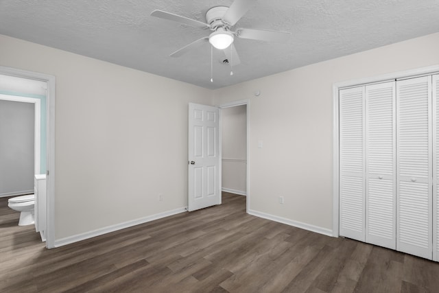 3007 Tallwood Way, Augusta, GA 30906 - unfurnished bedroom with dark wood-style floors, a closet, a textured ceiling, connected bathroom, and a ceiling fan