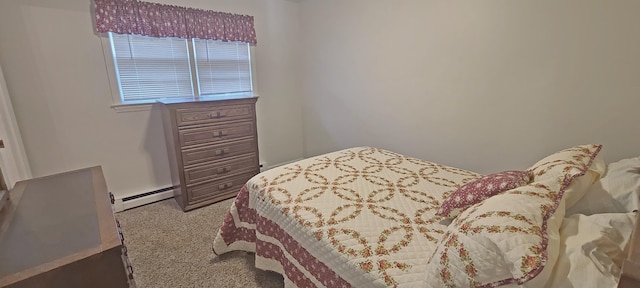 carpeted bedroom featuring baseboard heating