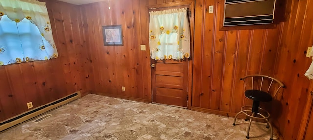 entryway featuring a baseboard heating unit and wood walls