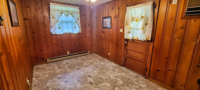 doorway to outside with a baseboard radiator and wooden walls