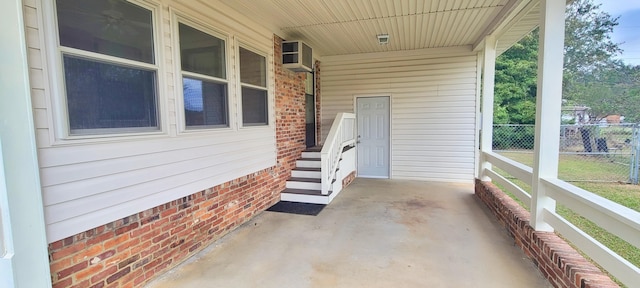 view of patio featuring a wall unit AC