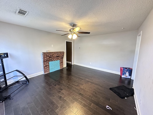 unfurnished living room with ceiling fan, dark hardwood / wood-style floors, and a textured ceiling