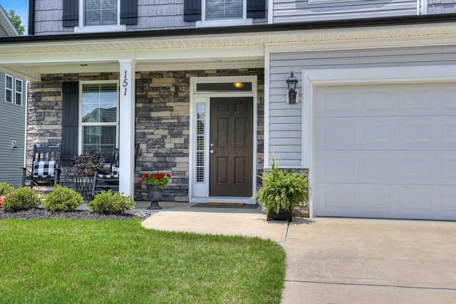 doorway to property featuring a porch and a garage