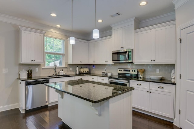 kitchen with a center island, sink, white cabinetry, and stainless steel appliances