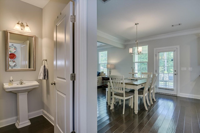 dining area featuring plenty of natural light, crown molding, and dark wood-type flooring