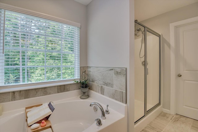 bathroom featuring tile patterned flooring, a shower with shower door, and a wealth of natural light