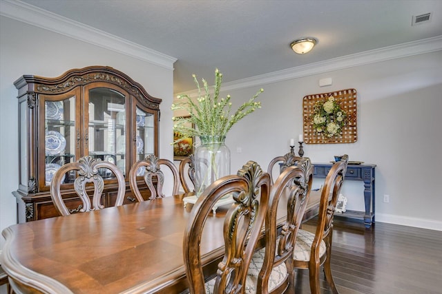 dining room featuring crown molding and dark wood-type flooring