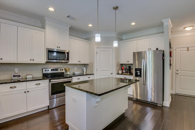 kitchen with white cabinets, backsplash, appliances with stainless steel finishes, and dark stone counters