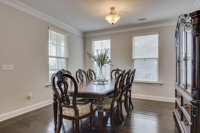 dining room featuring dark hardwood / wood-style floors and ornamental molding