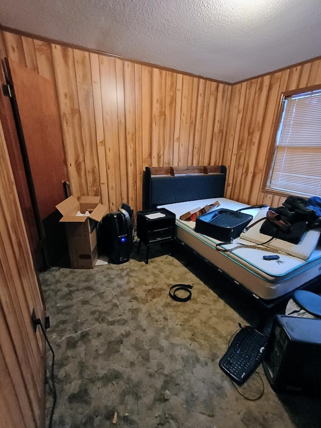 carpeted bedroom with wooden walls and a textured ceiling