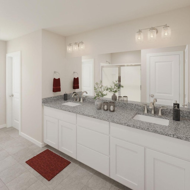 full bathroom featuring double vanity, a stall shower, baseboards, and a sink