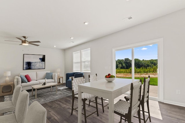 dining space with dark wood-style flooring, recessed lighting, visible vents, and baseboards